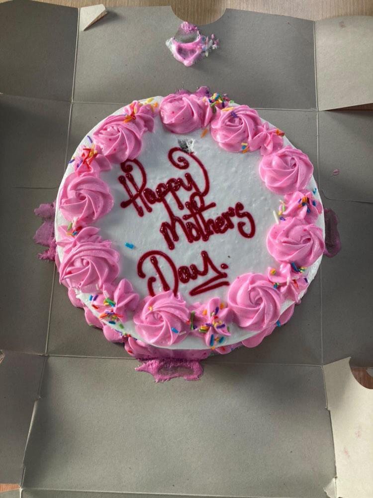 A pink and white Happy Mother's Day cake in its box