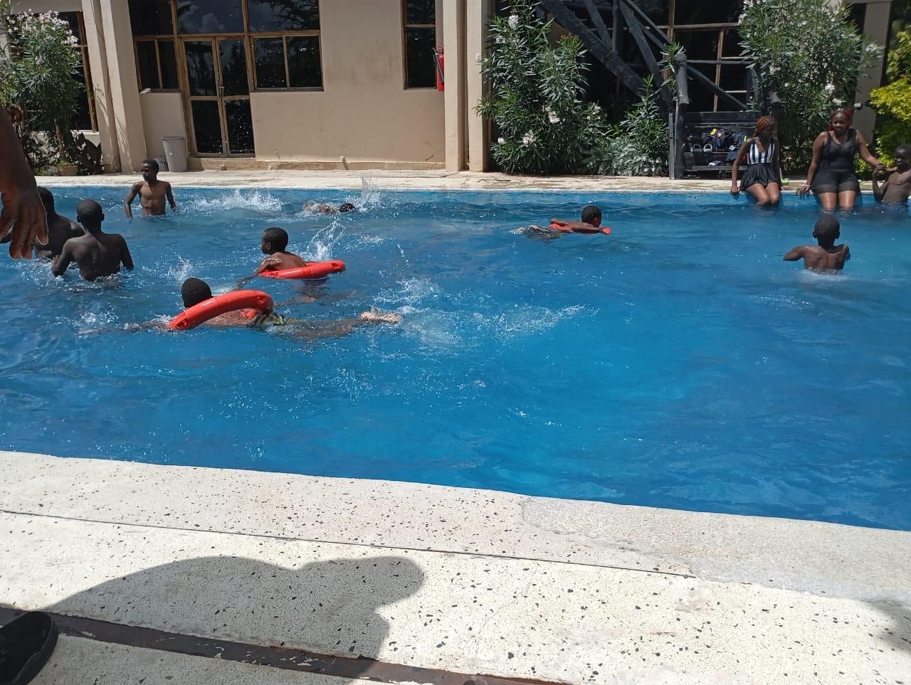 Children swimming at the pool on a fun day