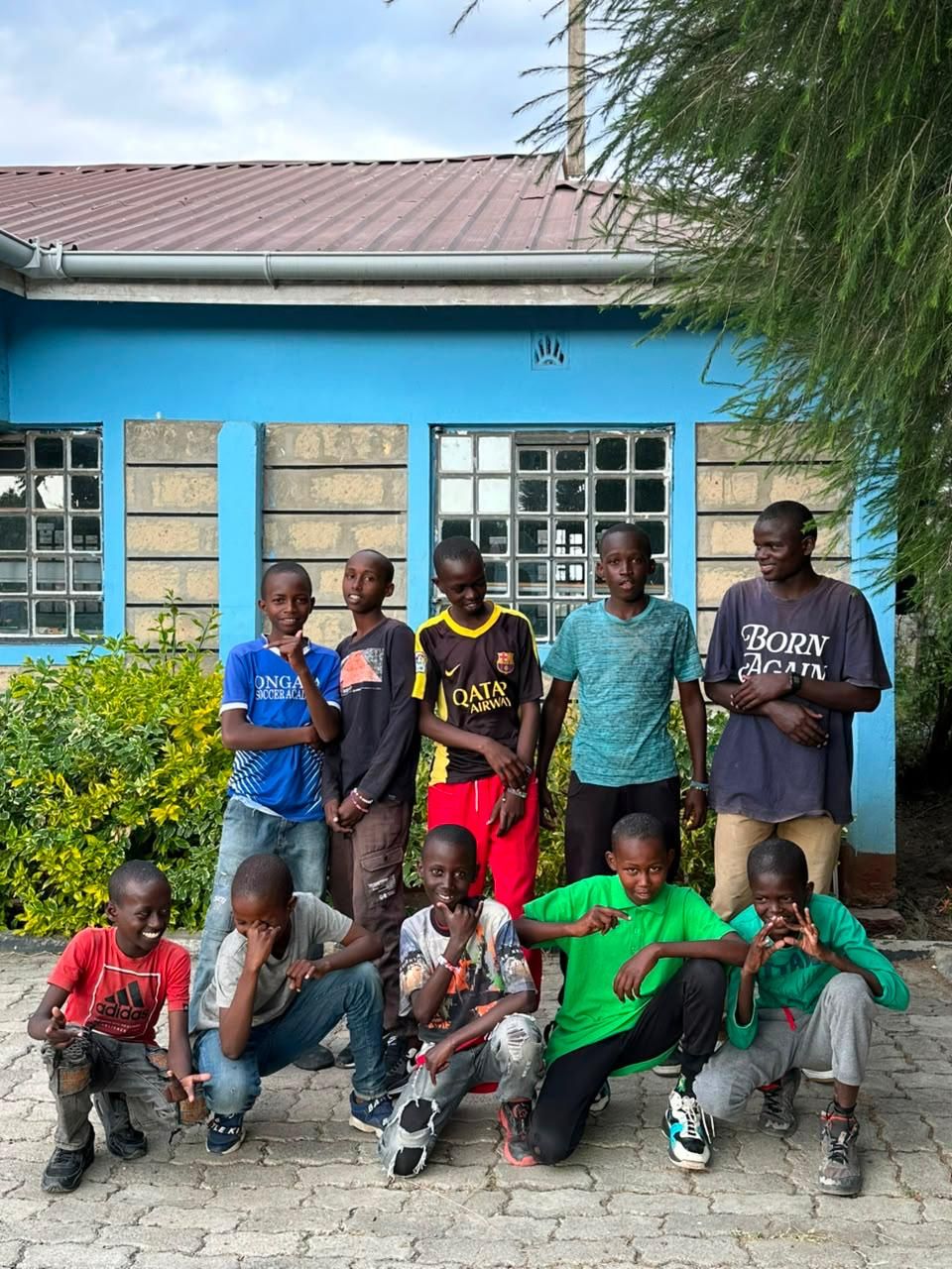 Boys standing in front of the Sons of Manasseh home