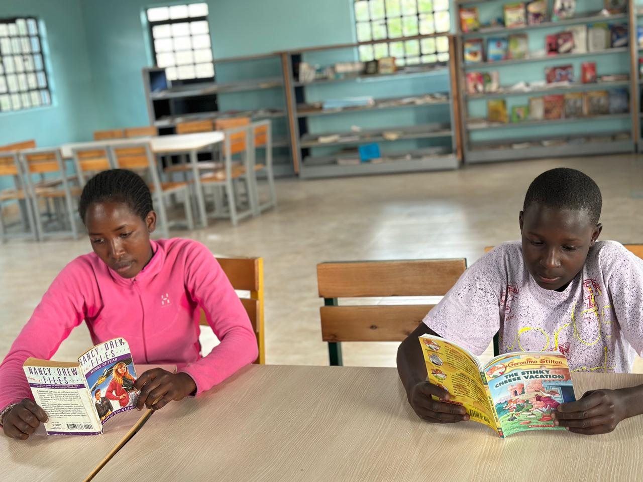 Two children reading in the reading room