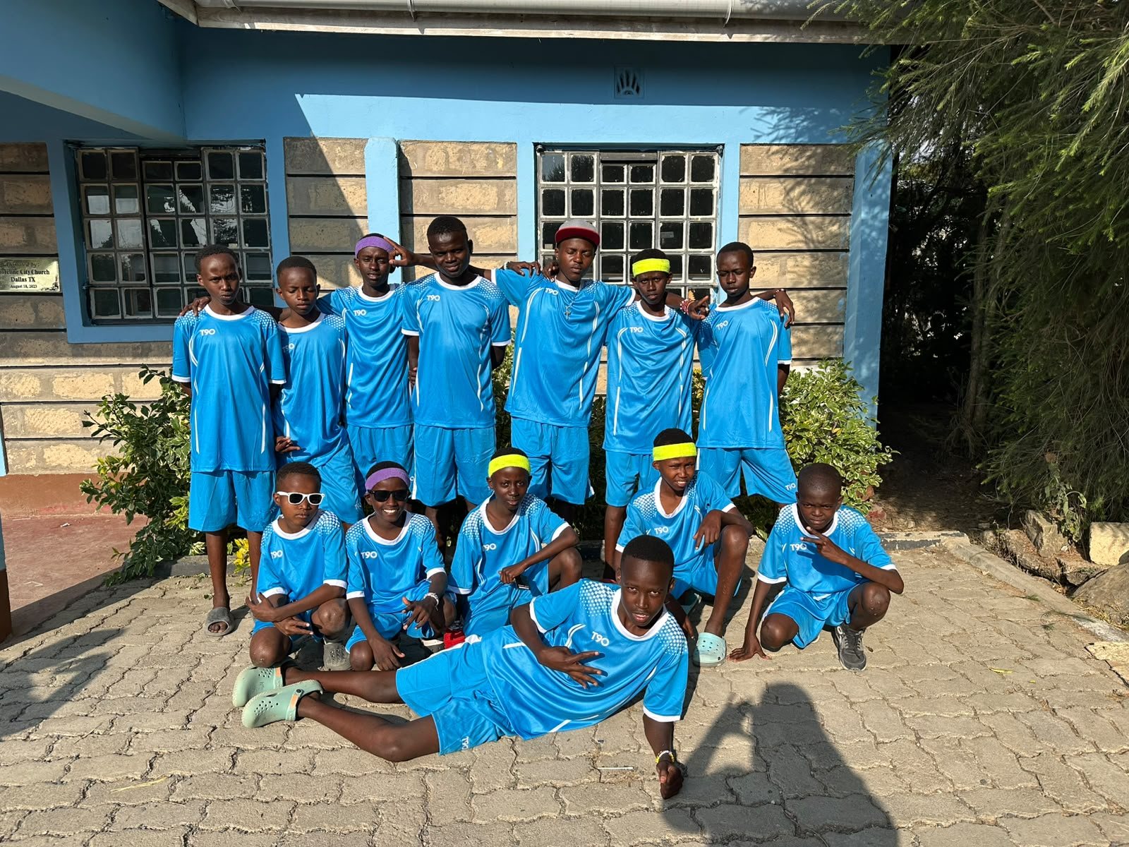 Members of the SMCH Football Club posing together in their blue kits